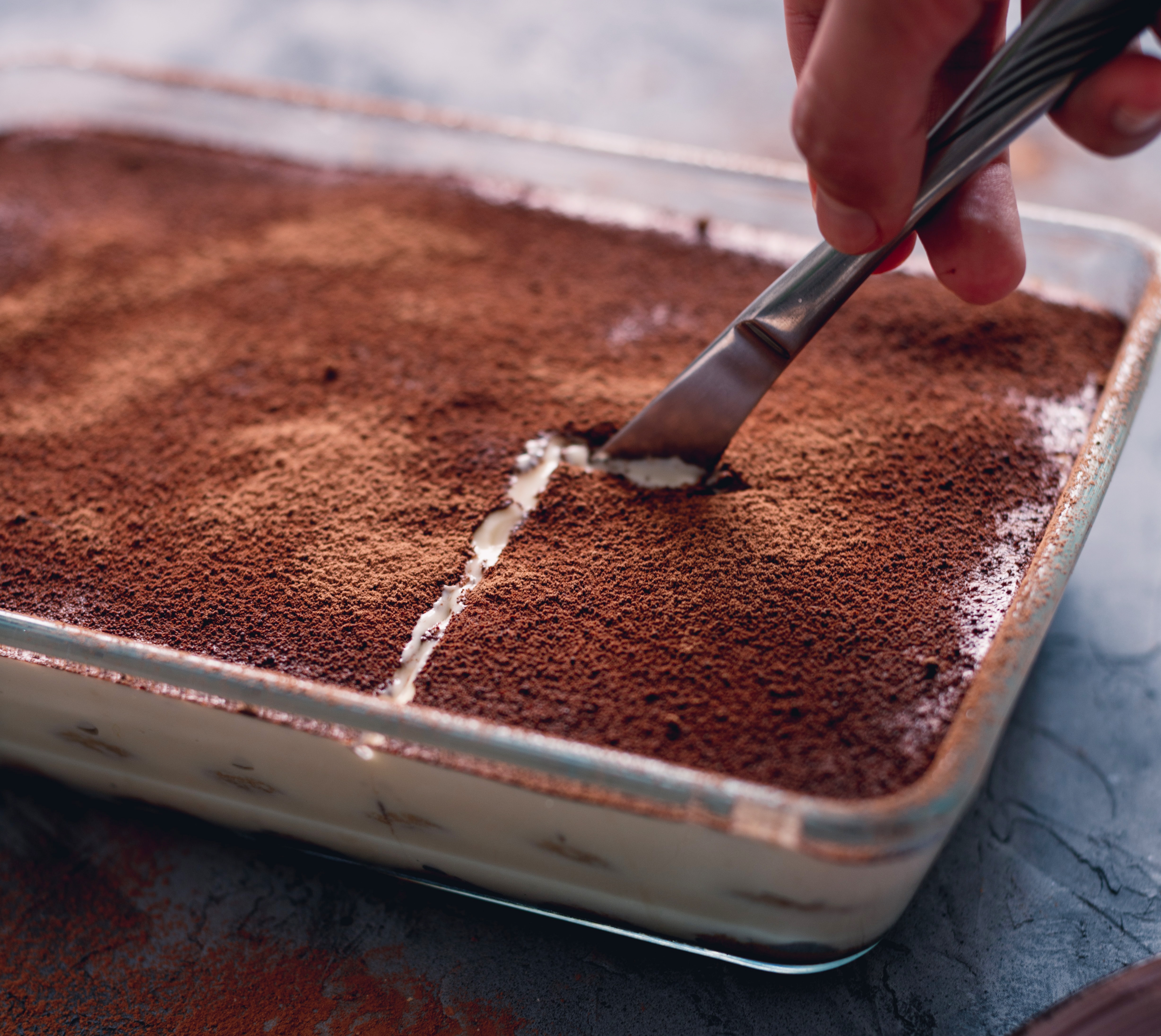 Tiramisu being delicately cut