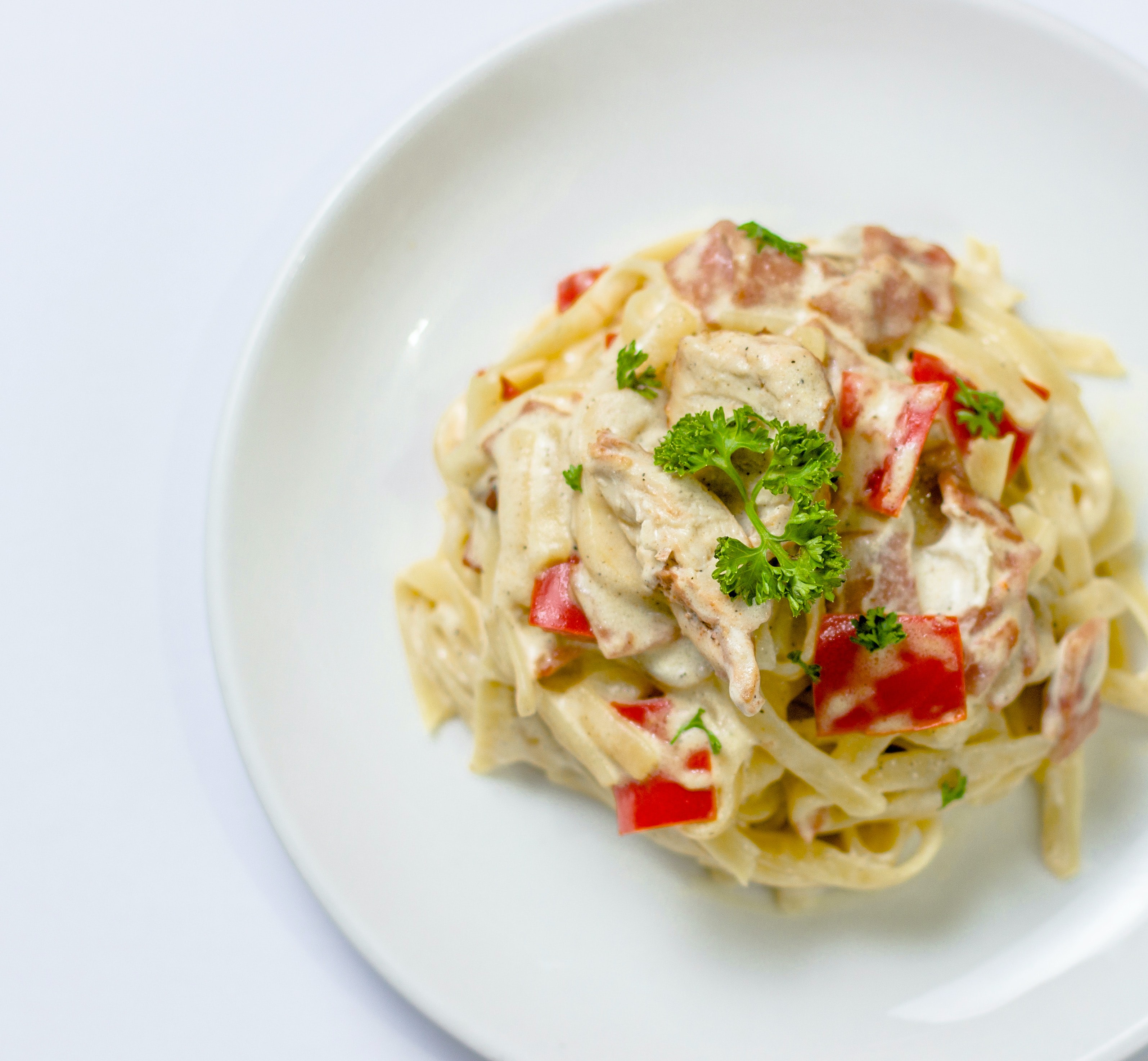 Spagetti in a large dish topped with herbs