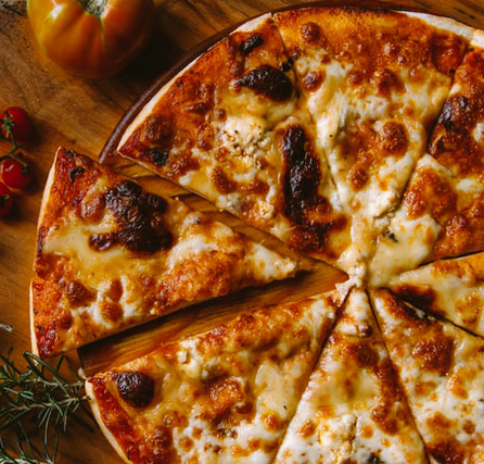 Pizza crust with red sauce topped with mozzarella